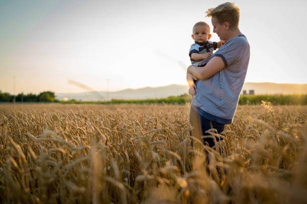 istock Mother and little son in a wheat field 1428107736