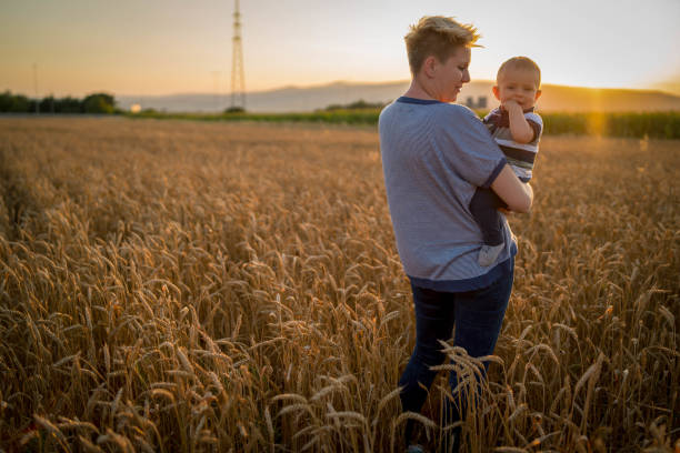 istock Mother and little son in a wheat field 1428107818