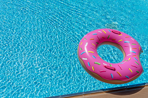 Inflatable pink donut in the swimming pool