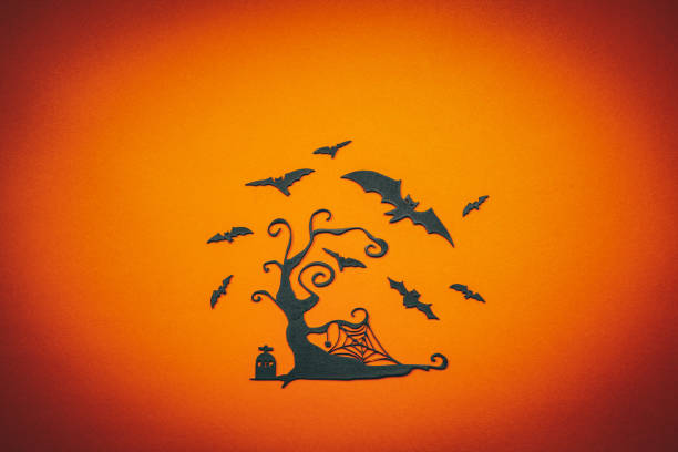 Black carved tree with flying bats.