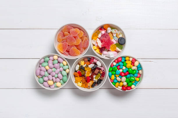 istock Colorful candies on wooden background 1428110885
