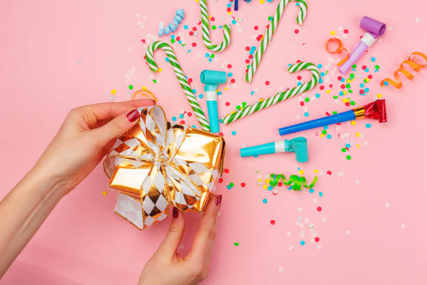 istock gift box with various party confetti, streamers and decoration 1428110891