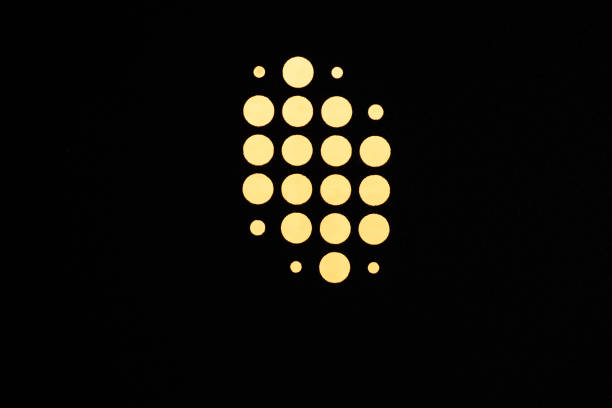 Circular patten of a metal plate lit up from behind.