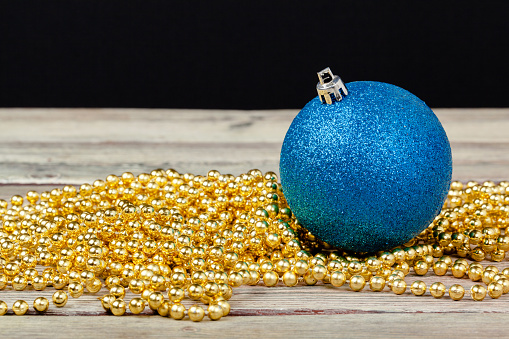 Photograph of a blue christmas bauble on snow.More like this: