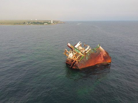 sunken ship, grounded transport ship, rusty skeleton of ship