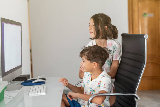 istock Two little brothers look at the computer and surf the internet together 1428113380