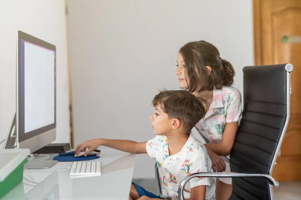 istock Two little brothers look at the computer and surf the internet together 1428113384