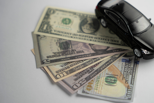 black and white colored cars and american currency dollar . . money and car