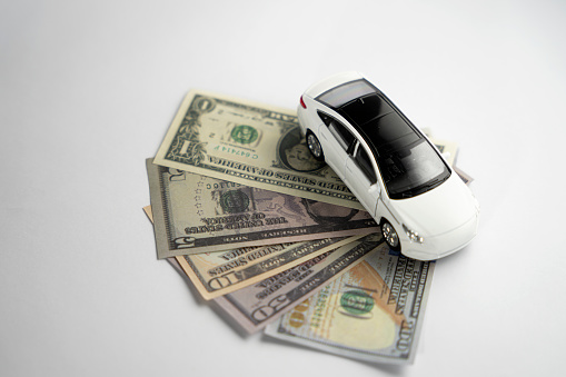 black and white colored cars and american currency dollar . . money and car