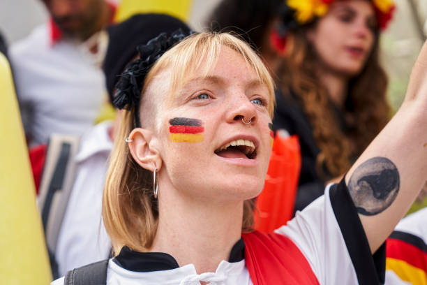 German woman cheering and chanting for Germany national team Close-up shot of German woman wearing face paint while cheering and chanting for Germany national football team in crowded stadium women under 20 stock pictures, royalty-free photos & images