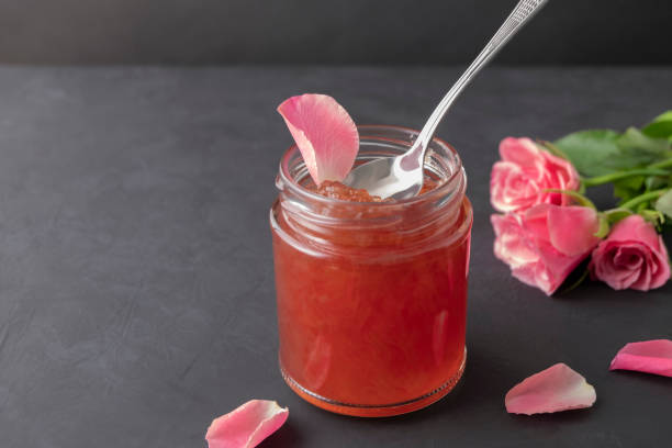 istock Jar of rose petal jam on dark background with copy space 1428119014