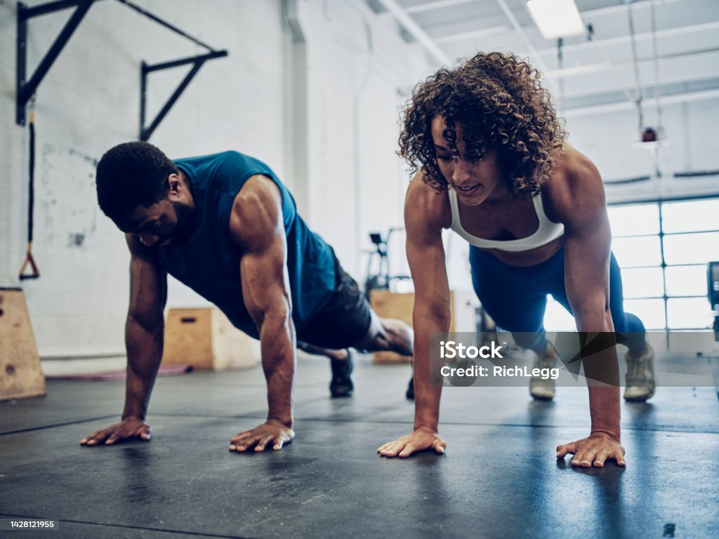 Two People Cross Training in a Gym An athletic couple cross training in a gym. Fitness Instructor Stock Photo