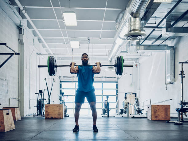 An athletic man cross training in a gym.