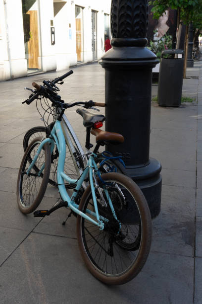istock bicycles resting on the street lamp 1428122591