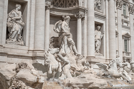 Couple contemplating the Trevi fountain in Rome, Italy\nPeople travel enjoying capital cities of Europe concept