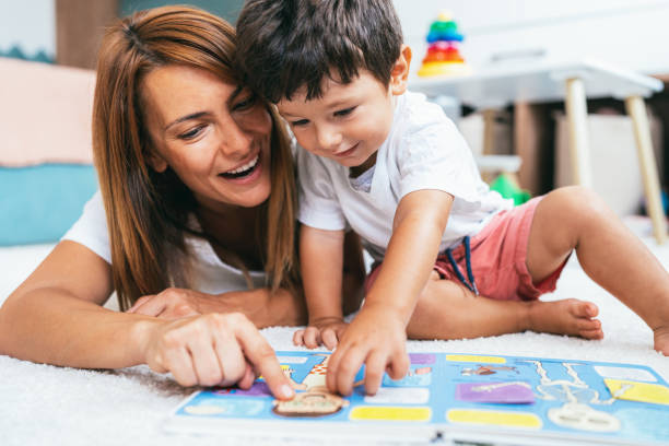 istock Mother reading book with her boy 1428126780