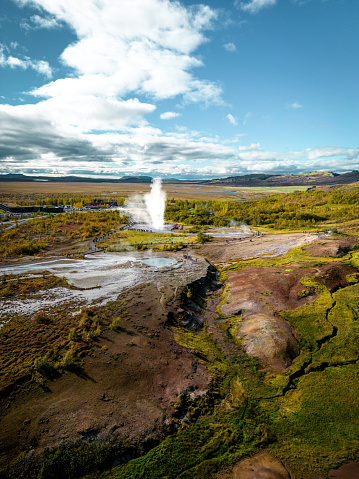 Strokkur is a fountain-type geyser located in a geothermal area beside the Hvítá River in Iceland. It reaches heights between 15–20 metres although it can sometimes erupt up to 40 metres high. Vertical photo.