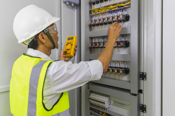 istock Electrician installing electric cable wires and fuse switch box. Multimeter in hands of electricians detail. 1428130161