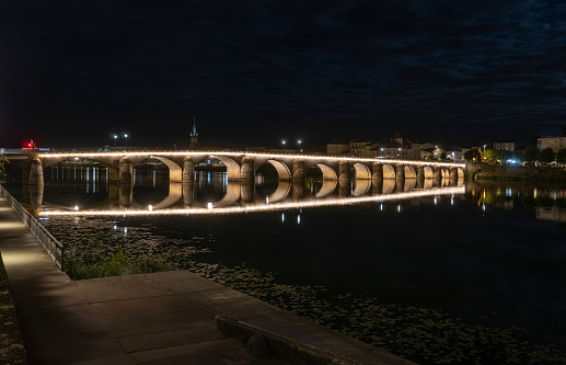 Mâcon, Burgundy, September 2022: Old stone bridge Saint Laurent on Saône River, illuminated in the night