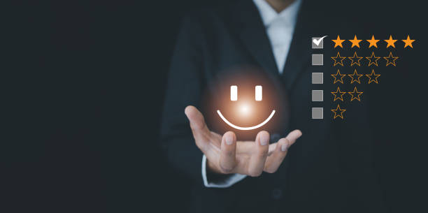istock Customer Service Assessment Concept. Businessman holding smiley face showing virtual emoticon, survey, poll or questionnaire for user experience or customer satisfaction research. 1428131648