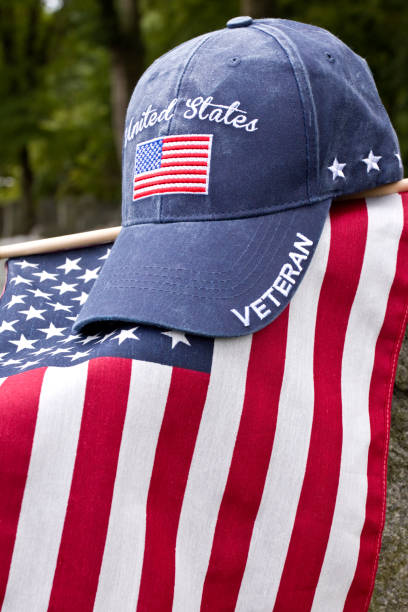 istock American Flag, Veterans cap on grave marker 1428132318
