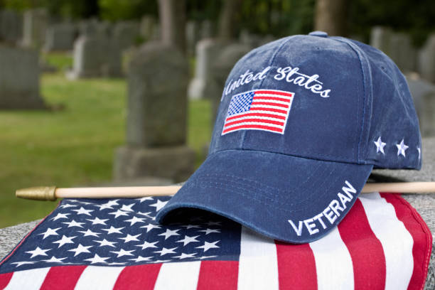 istock American Flag, Veteran cap on grave marker 1428132327