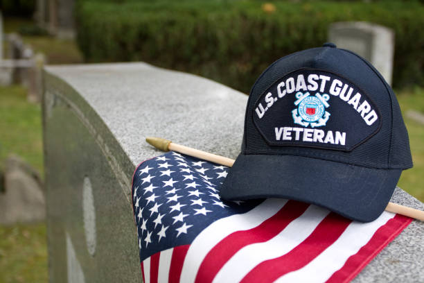istock US Coast Guard Veterans cap on flag in cemetery 1428132528