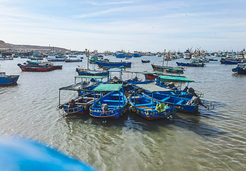 Boats floating in the sea, in Paita Harbor, Peru. Fishing boats gathered floating in the sea.