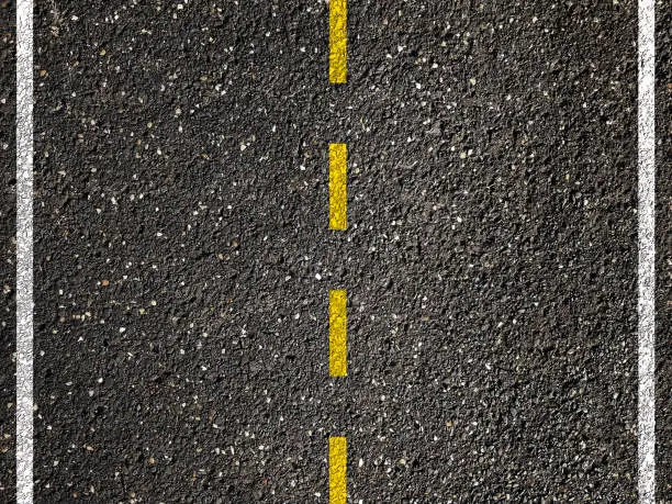 Yellow line on asphalt road background.