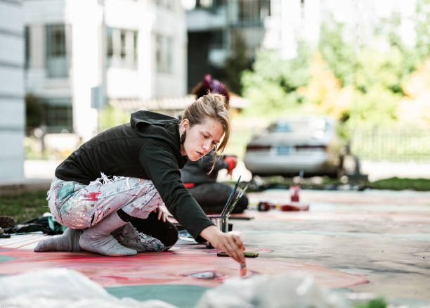 istock Young Caucasian woman creating outdoor mural 1428150718