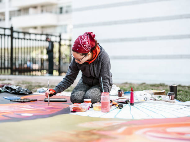 istock Young Latin woman creating outdoor mural 1428150722