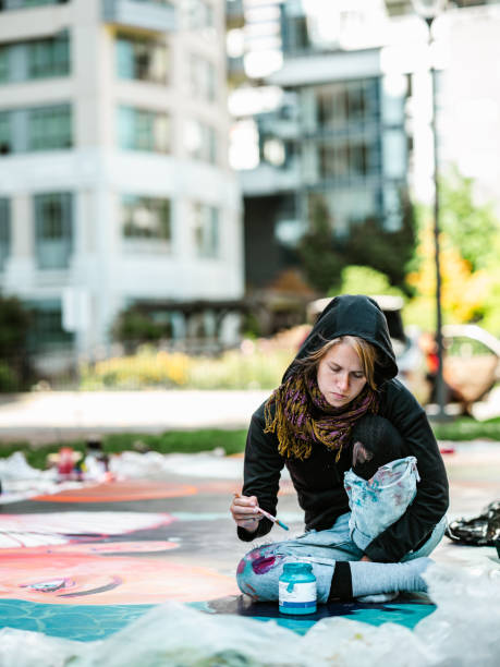 istock Young Caucasian woman creating outdoor mural 1428150805