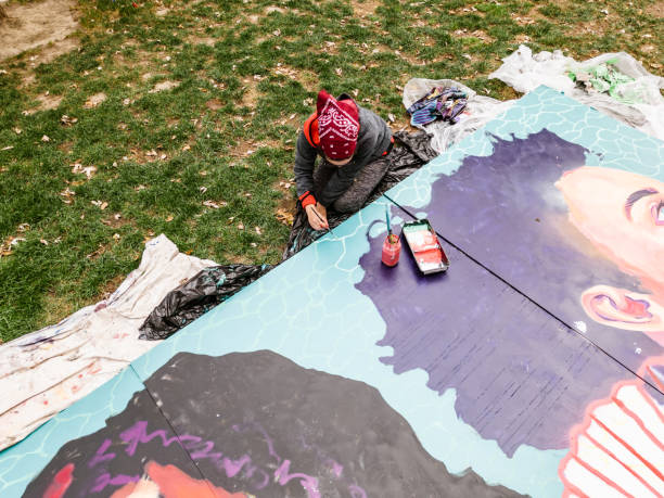 istock Young Latin woman creating outdoor mural 1428150864