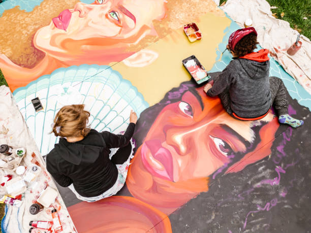 istock Two Young female artists creating outdoor mural 1428150865