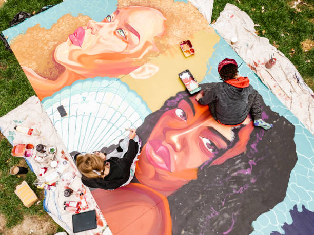 istock Two Young female artists creating outdoor mural 1428150893
