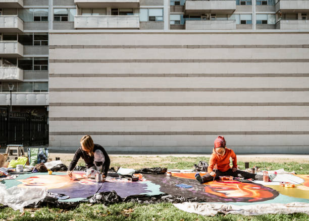 istock Two Young female artists creating outdoor mural 1428150922