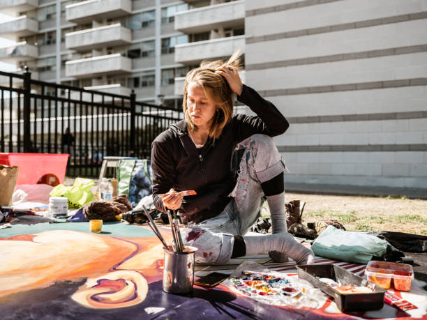 istock Young Caucasian woman creating outdoor mural 1428150944