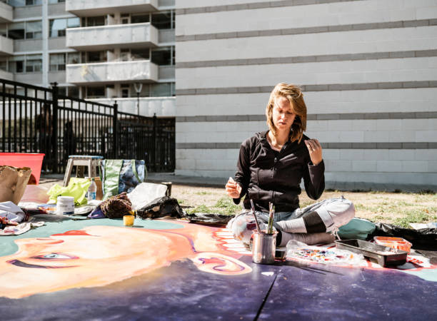 istock Young Caucasian woman creating outdoor mural 1428150954
