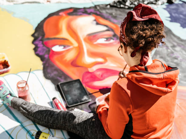 istock Young Latin woman creating outdoor mural 1428150972