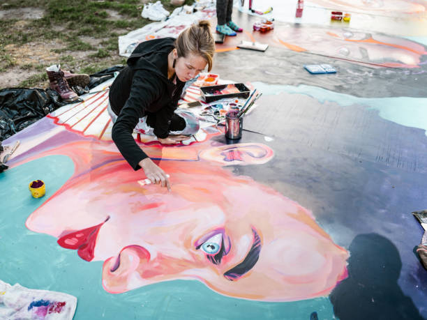 istock Young Caucasian woman creating outdoor mural 1428152021