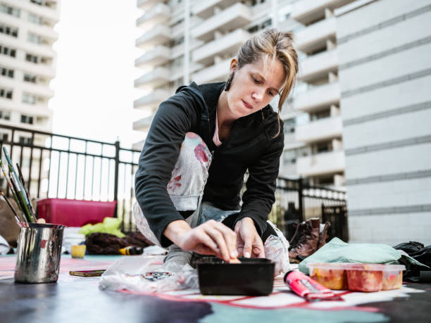 istock Young Caucasian woman creating outdoor mural 1428152664