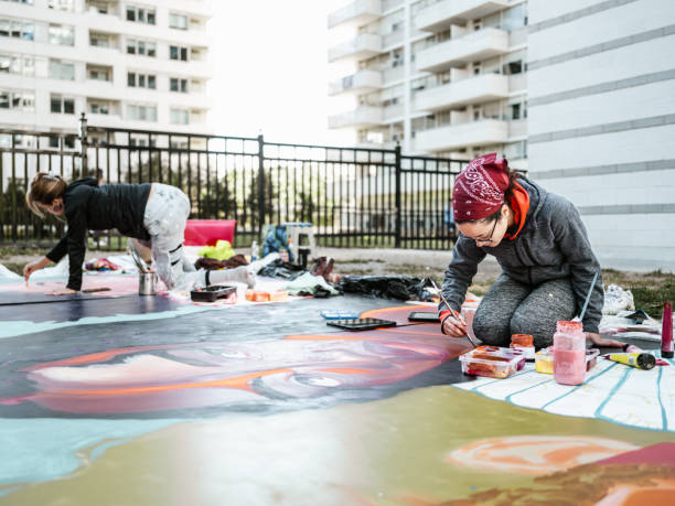 istock Two Young female artists creating outdoor mural 1428153600