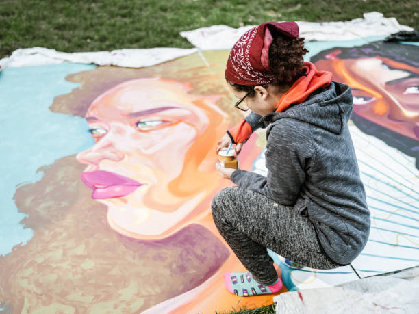 istock Young Latin woman creating outdoor mural 1428154138