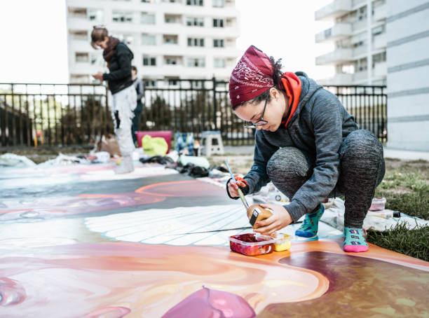 istock Two Young female artists creating outdoor mural 1428154141