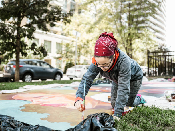 istock Young Latin woman creating outdoor mural 1428154157