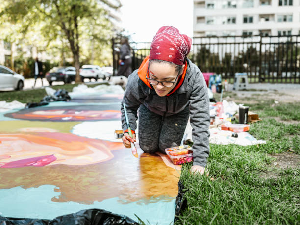 istock Young Latin woman creating outdoor mural 1428154206