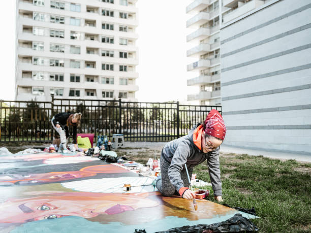 istock Two Young female artists creating outdoor mural 1428154209