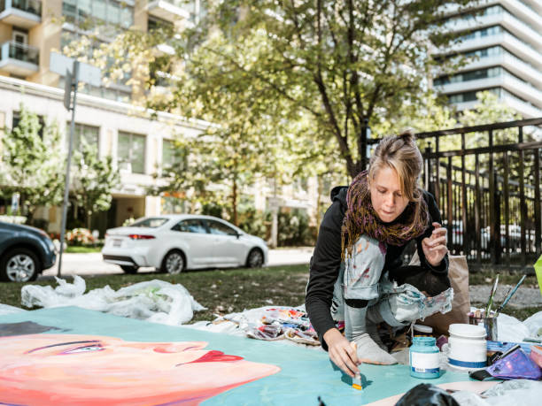 istock Young Caucasian woman creating outdoor mural 1428154233