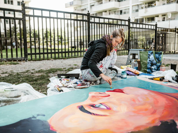 istock Young Caucasian woman creating outdoor mural 1428154246