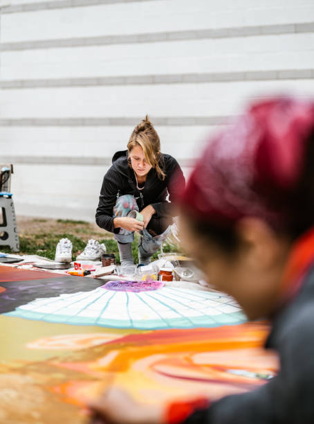istock Two Young female artists creating outdoor mural 1428154360